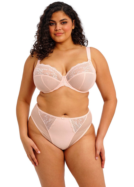 curvy woman wearing a big cup bra in pink lace with embroidered flowers