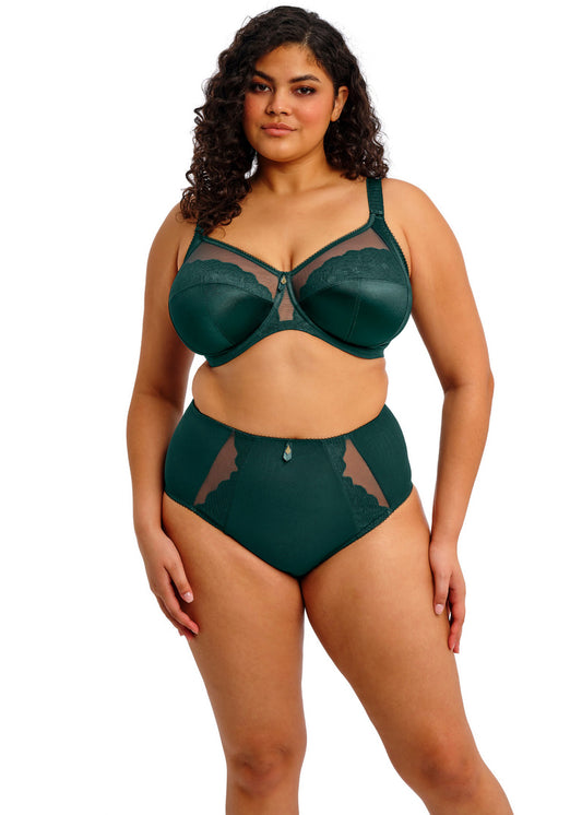 curvy woman wearing a deep emerald satin bra with lace details and matching brief