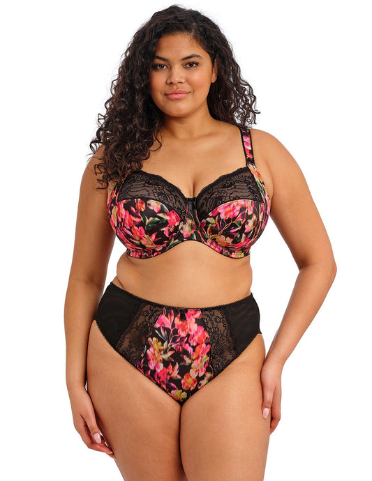 curvy woman wearing a plussize bra in black with colourfull printed flowers and stretch lace and matching briefs