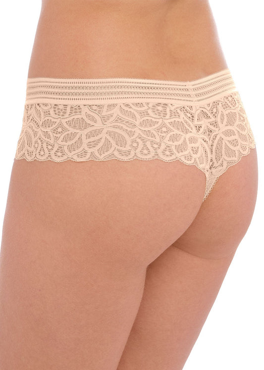 woman wearing a lace tanga in nude color