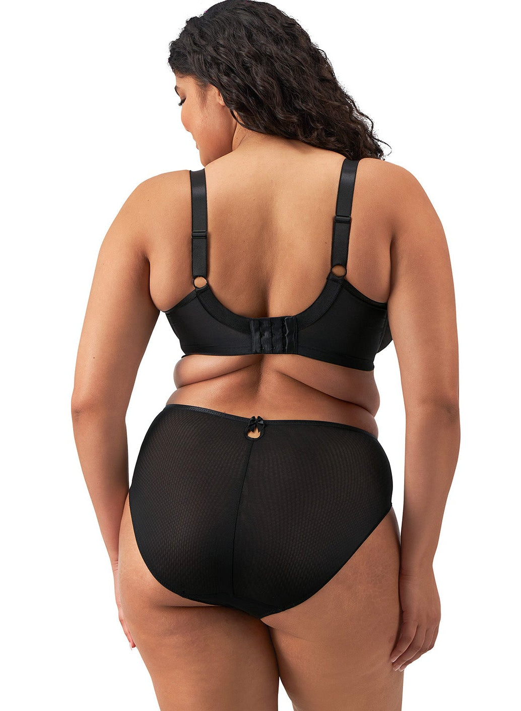 curvy woman wearing a black big cup bra with lace and embroidered flowers in almond colour
