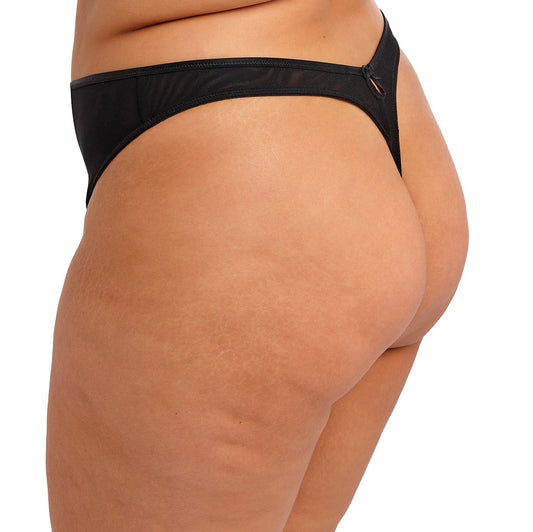 curvy woman wearing a black thong with lace and embroidered flowers in summer colours