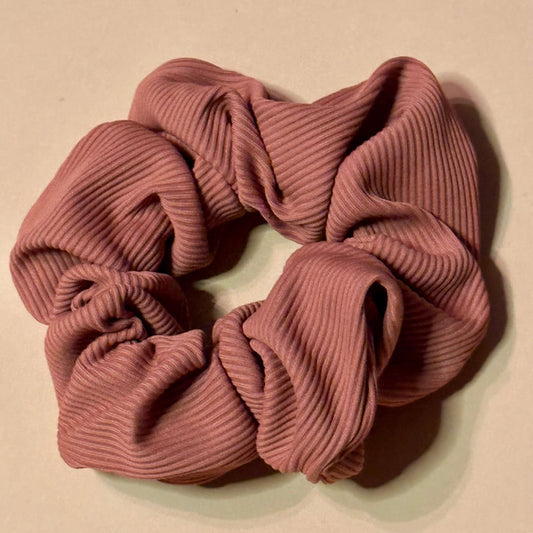 Pink rosewood scrunchie on a beige background
