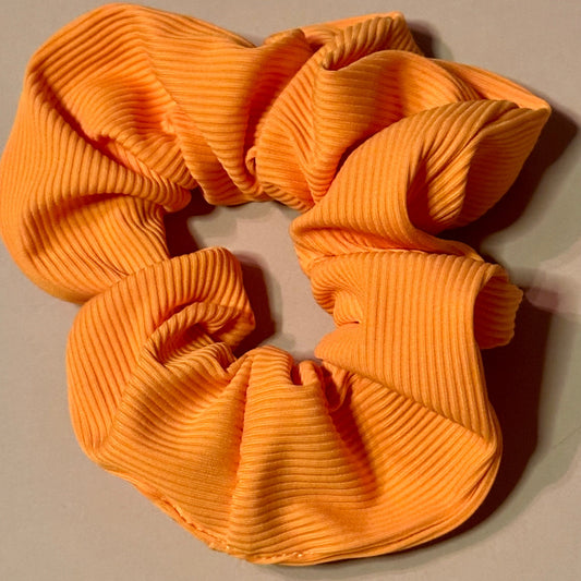 yellow ribbed scrunchie on a beige background