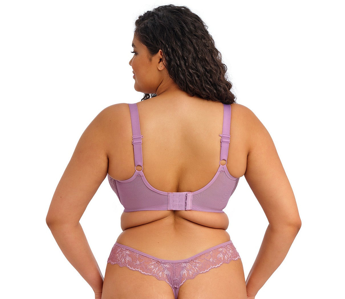 curvy woman wearing a padded big cup plunge bra in heather purple against a white background