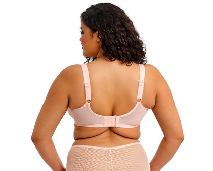 curvy woman wearing a big cup bra in pink lace with embroidered flowers