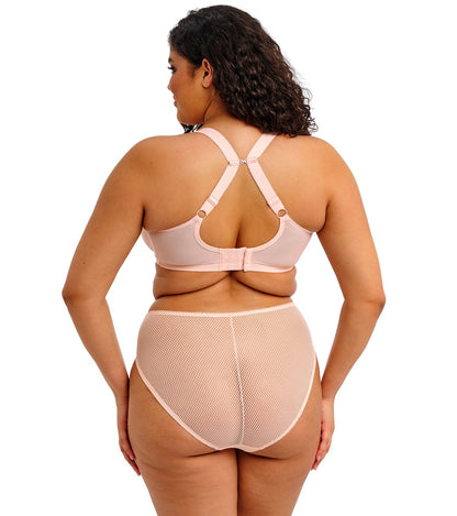 curvy woman wearing a big cup bra in pink lace with embroidered flowers