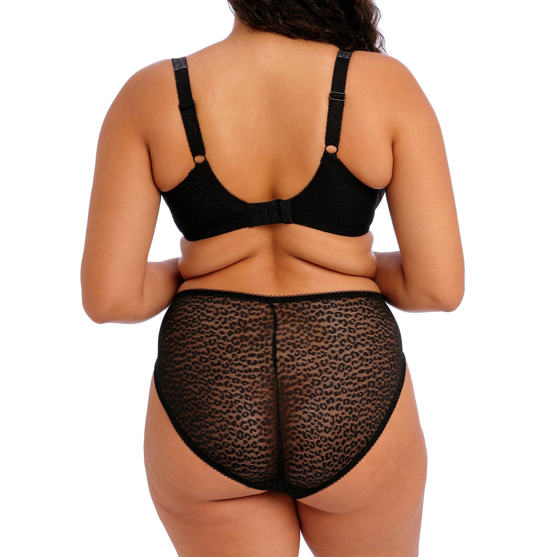 curvy woman wearing Black lace underwear with leopard print trim on a white background