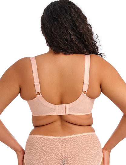 curvy woman wearing a big cup bra with flower pattern and lace in pink color