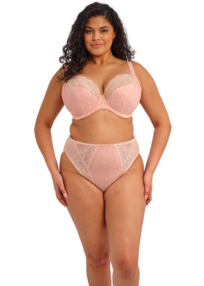curvy woman wearing a big cup bra with flower pattern and lace in pink color