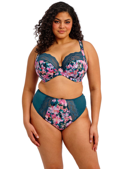curvy woman wearing a big cup bra with flower pattern and lace in teal color