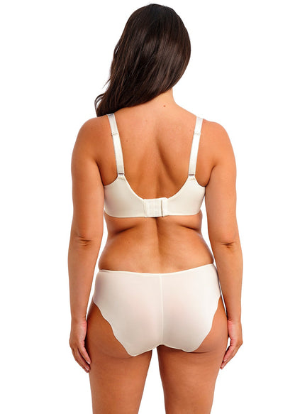 curvy woman wearing a big cup bra with embroidered flowers and lace in ivory color