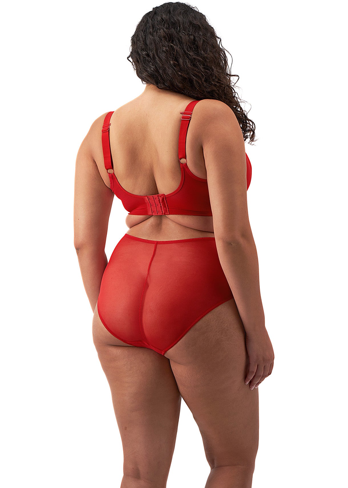 curvy woman wearing a plussize bra with mesh panels in red color against a white background