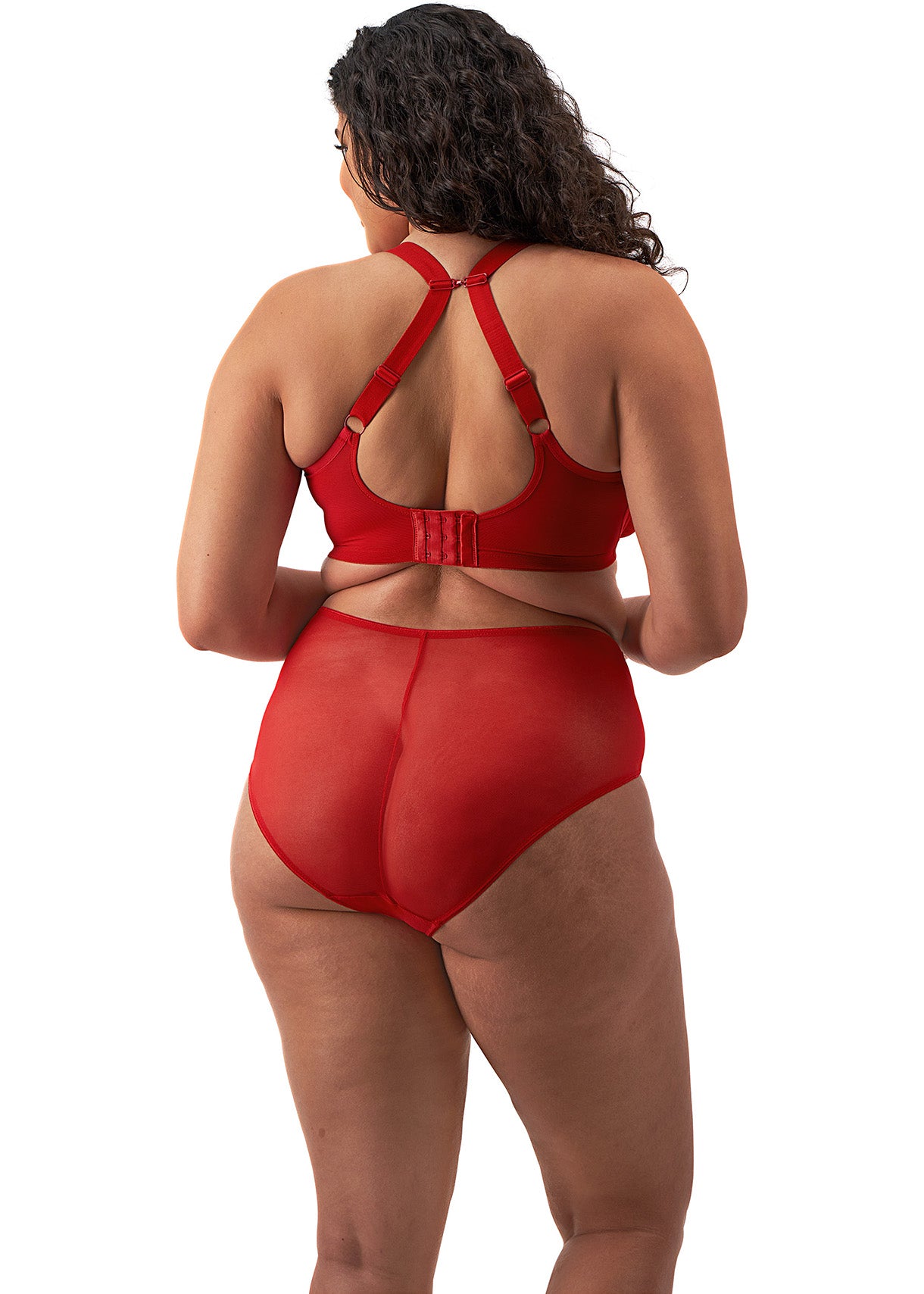 curvy woman wearing a plussize bra with mesh panels in red color against a white background