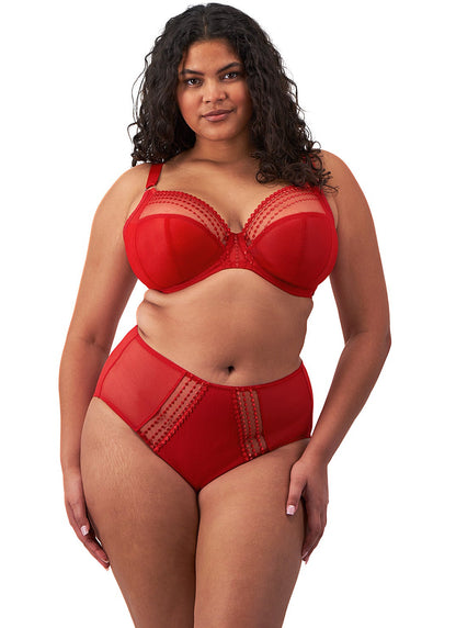 curvy woman wearing a plussize bra with mesh panels in red color against a white background