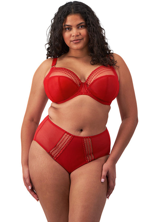 curvy woman wearing a plussize bra with mesh panels in red color against a white background