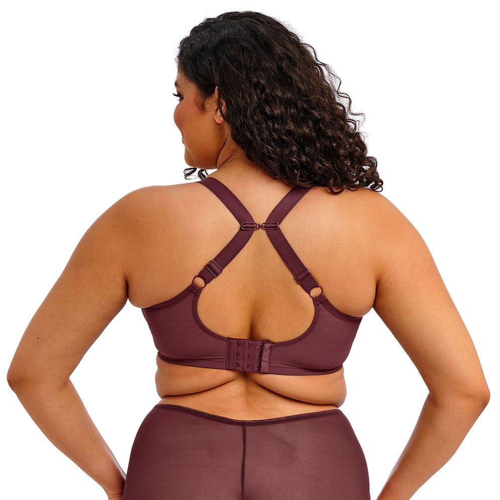 curvy woman wearing a purple lingerie set on a white background