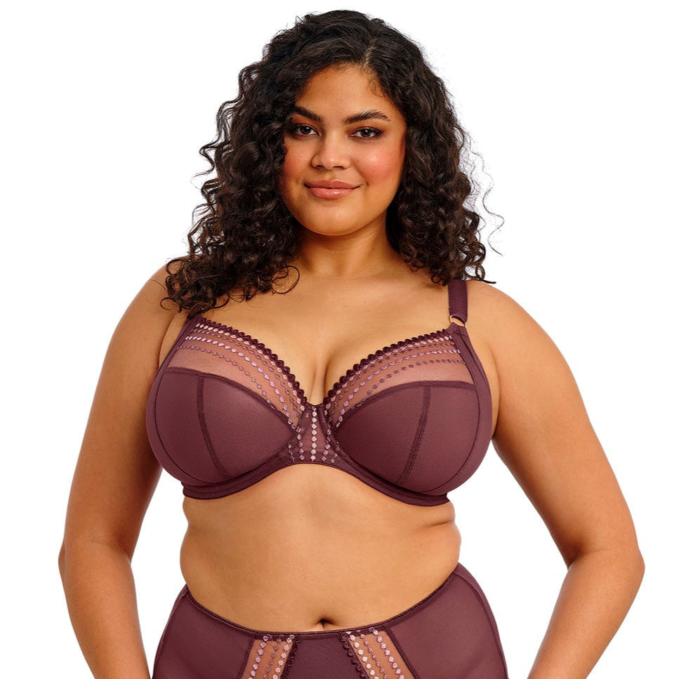 curvy woman wearing a purple lingerie set on a white background