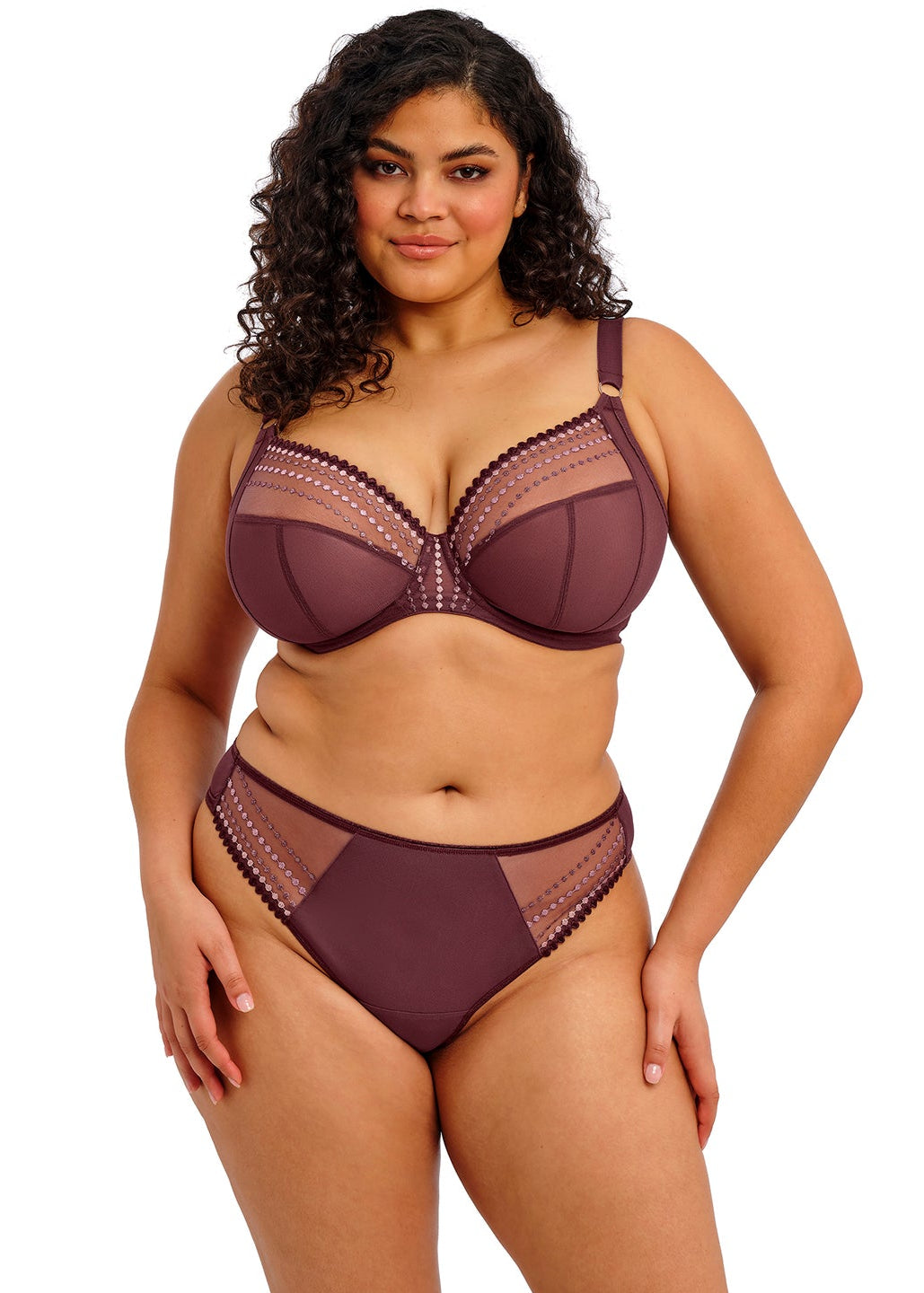curvy woman wearing a purple lingerie set with lace trim on a white background
