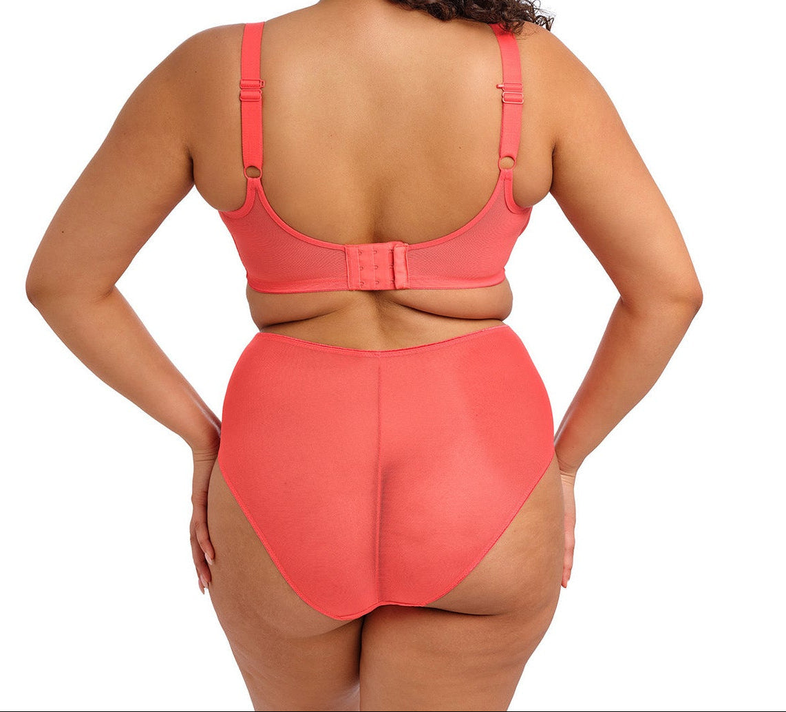 curvy woman wearing a sunset color lingerie set on a white background