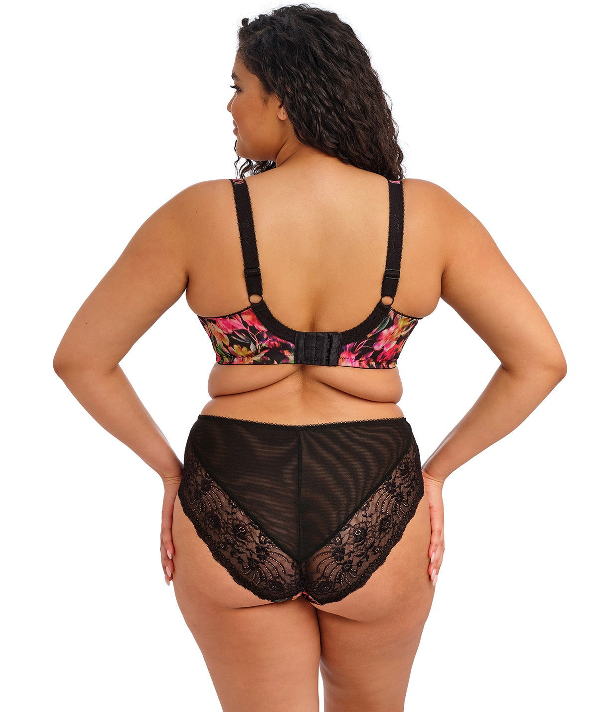 curvy woman wearing a black plussize high waist brief with mesh lace panels and printed colorfull flowers