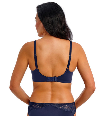 woman wearing a dark blue bra with mesh , lace details and strass accents