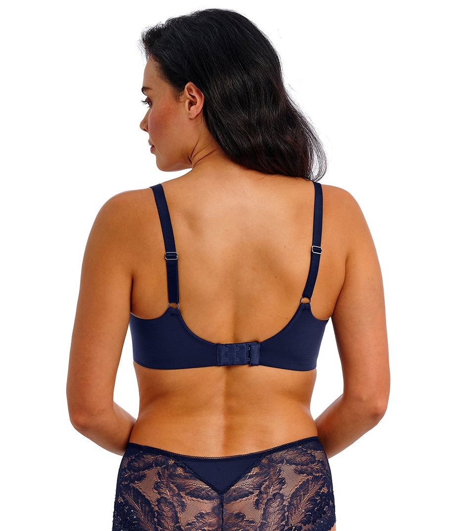 woman wearing a blue lace plunge bra with little strass details