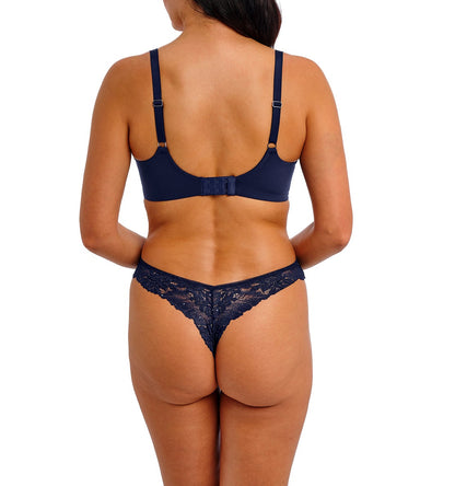 woman wearing a tanga in  blue lace wit little strass details