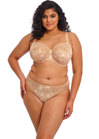 curvy woman wearing a big cup bra in beige with subtile leaves print and stretch lace 