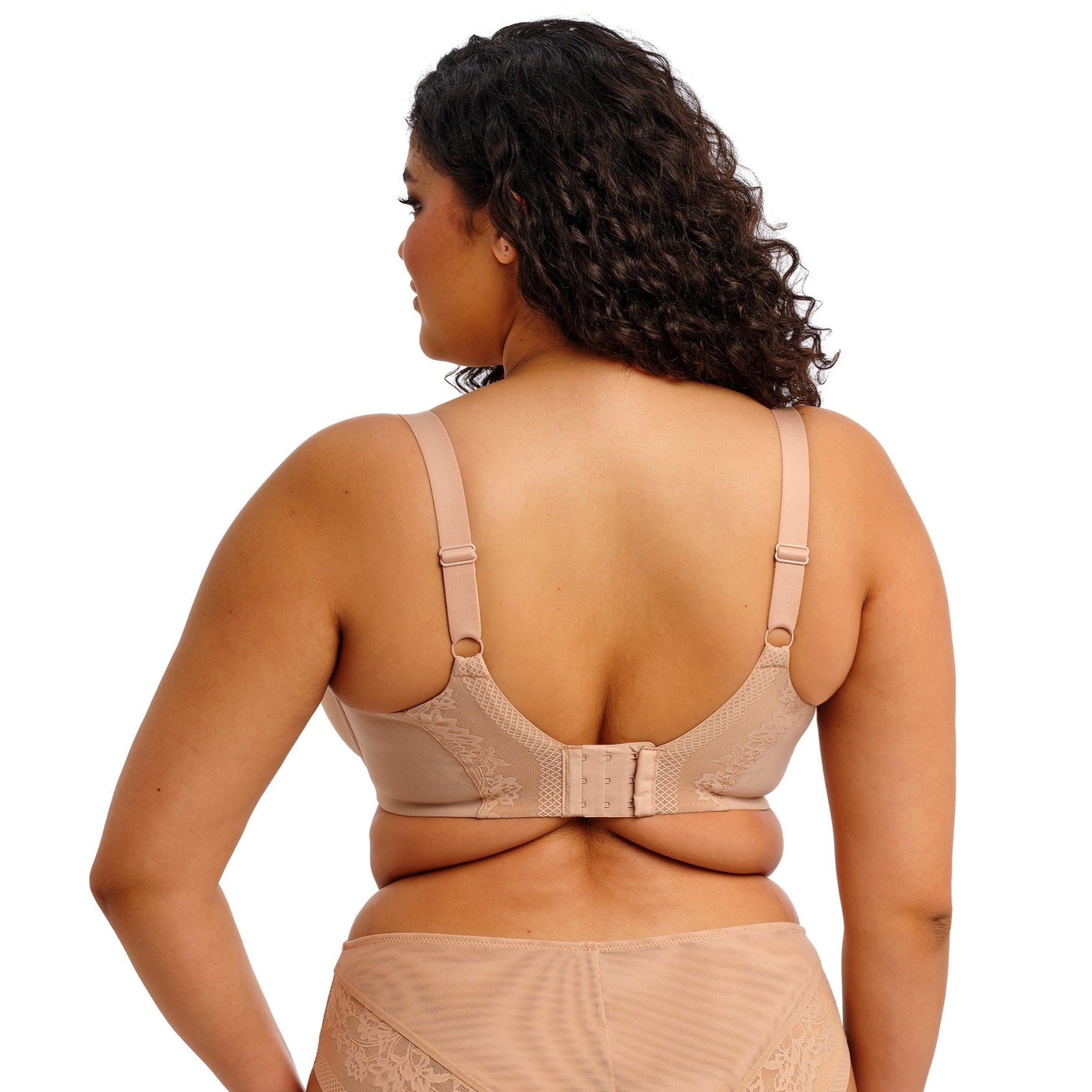 Curvy woman wearing beige lingerie against a white background