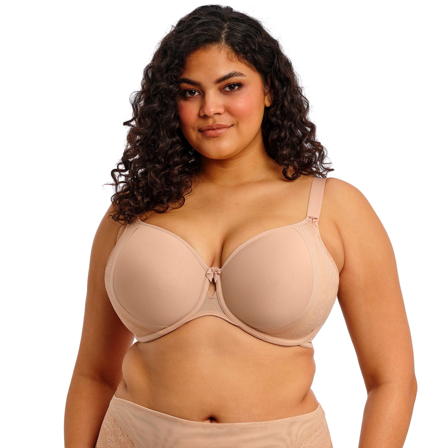 Curvy woman wearing beige lingerie against a white background