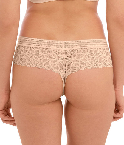 woman wearing a lace tanga in nude color