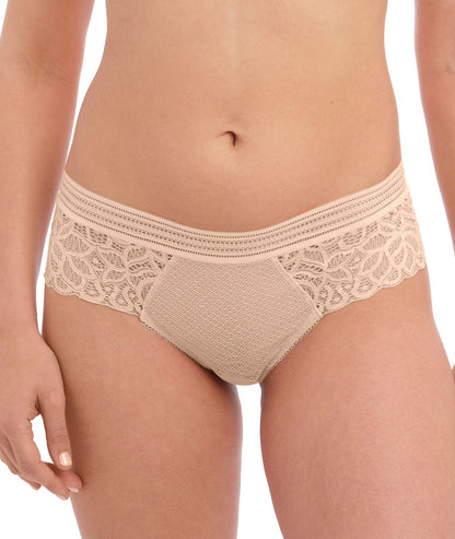 woman wearing a lace tanga in nude color