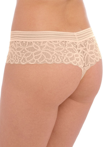woman wearing a lace tanga in nude color