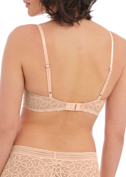 woman wearing a lace push up bra in nude color