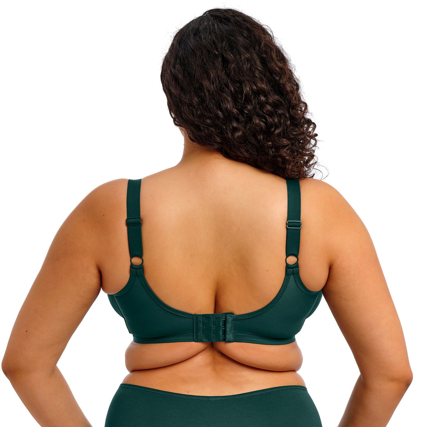 curvy woman wearing an emerald green lingerie set against a white background