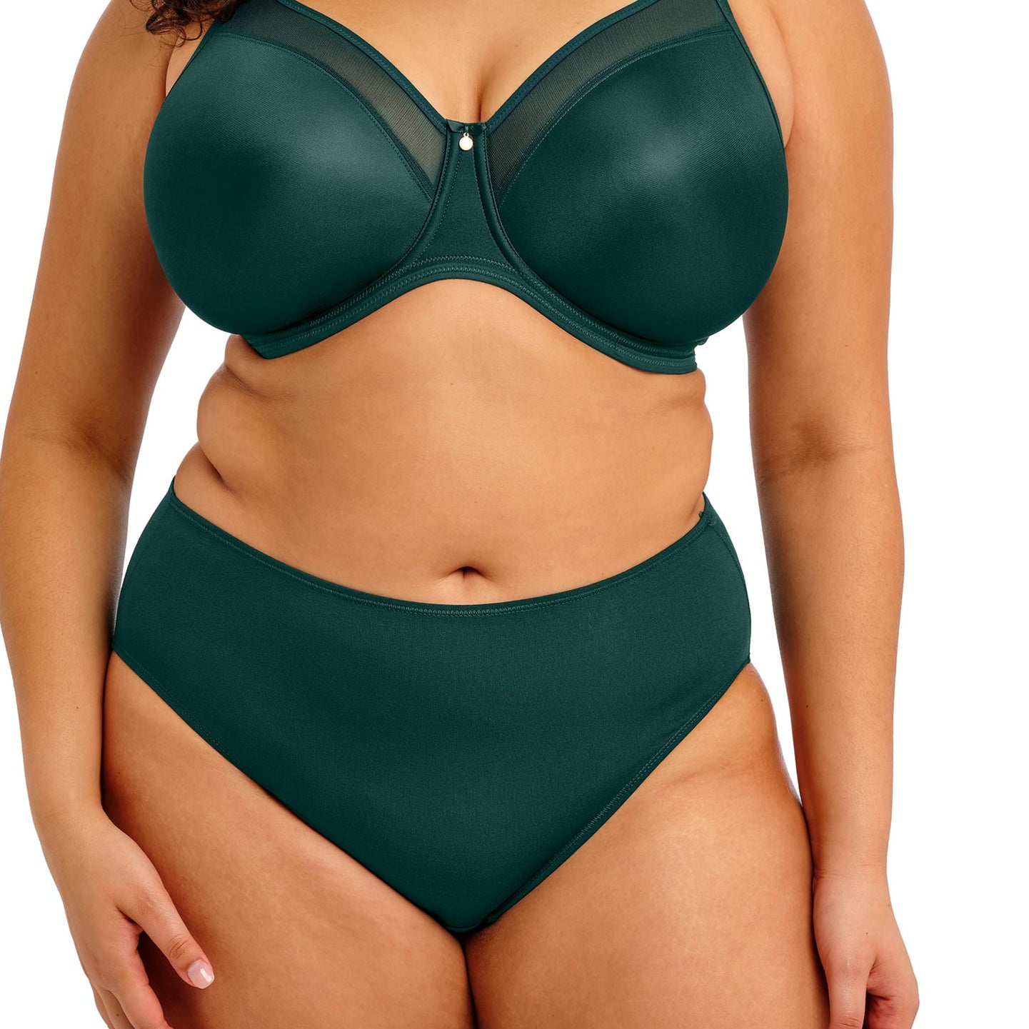 curvy woman wearing a emerald green high-waisted lingerie bottom on a white background