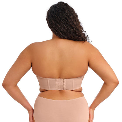 curvy woman wearing a beige strapless bra  against a white background