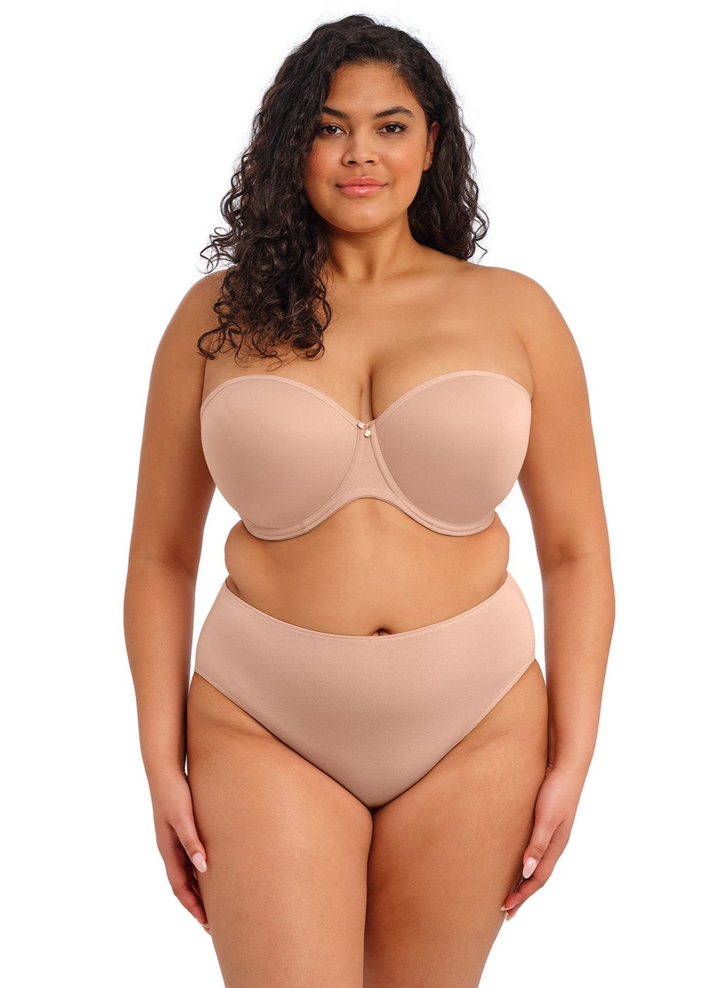 curvy woman wearing a beige strapless bra  against a white background