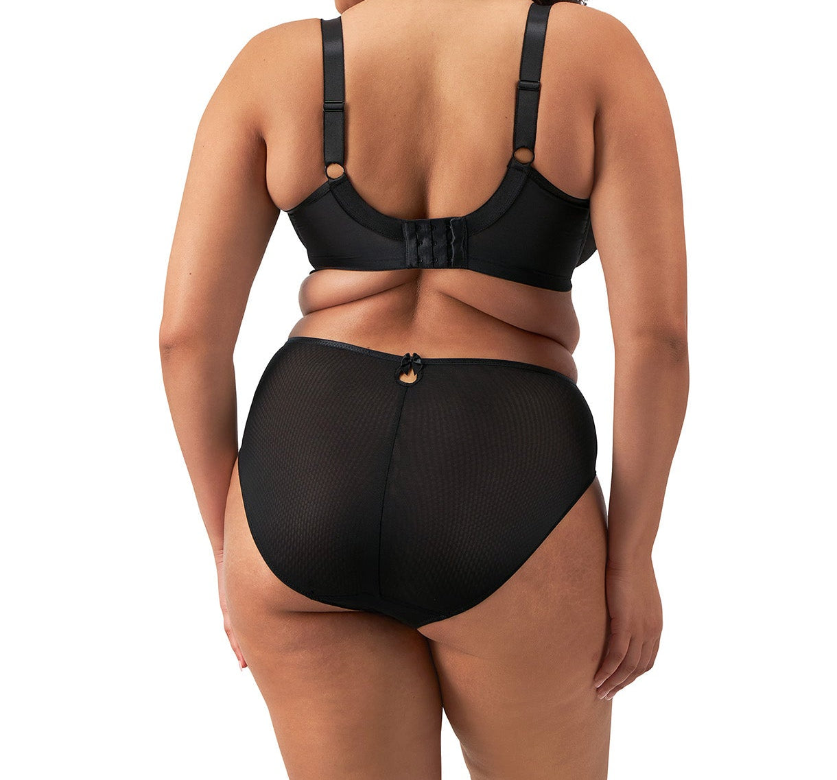 curvy woman wearing a plussize highwaist  highleg brief in black mesh with flower details in almond