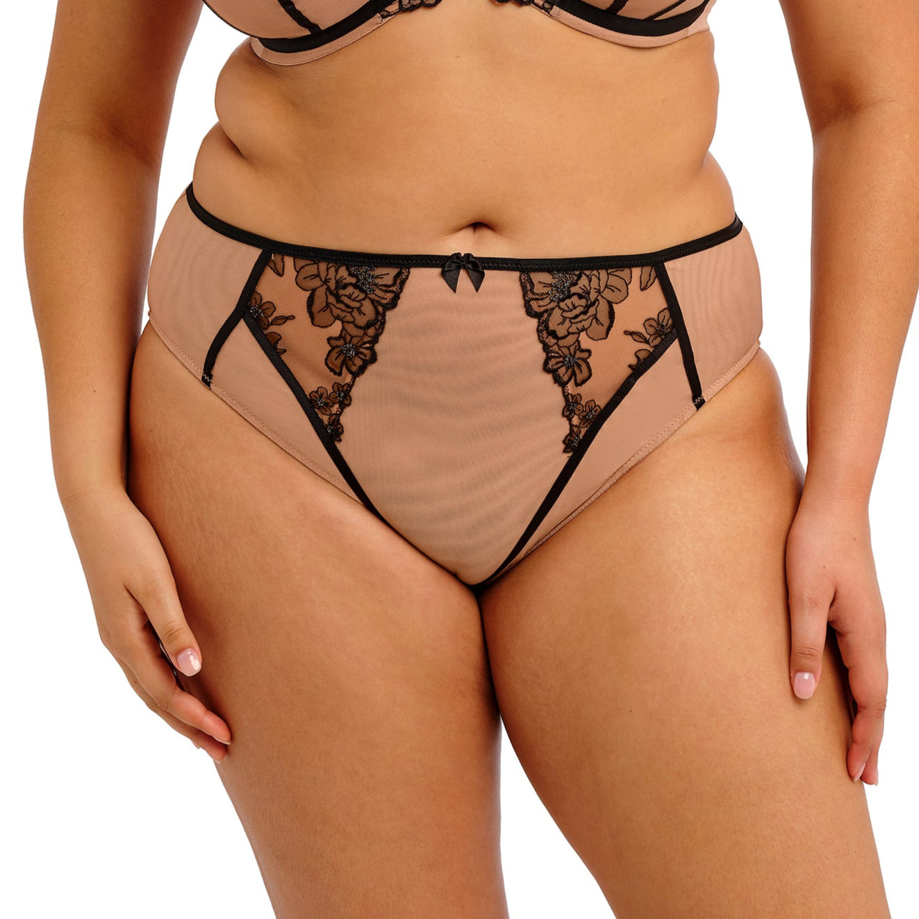 Beige underwear with black lace detailing on a white background