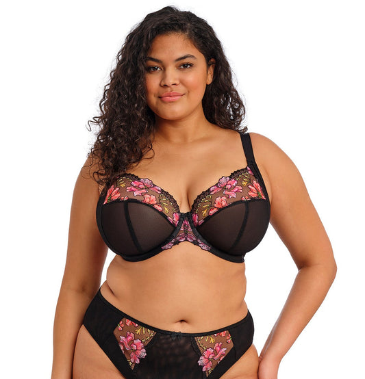 curvy woman wearing a black big cup bra with lace and embroidered flowers in summer colours