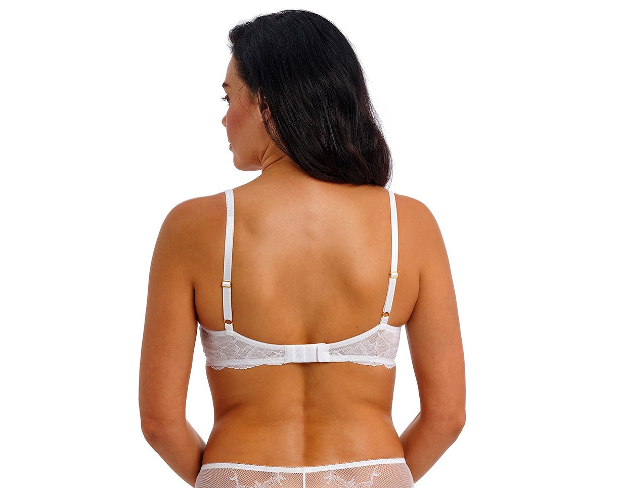 woman wearing a white lace bra with flower details