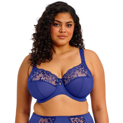 curvy woman wearing a Sapphire blue bra with floral lace details on a white background