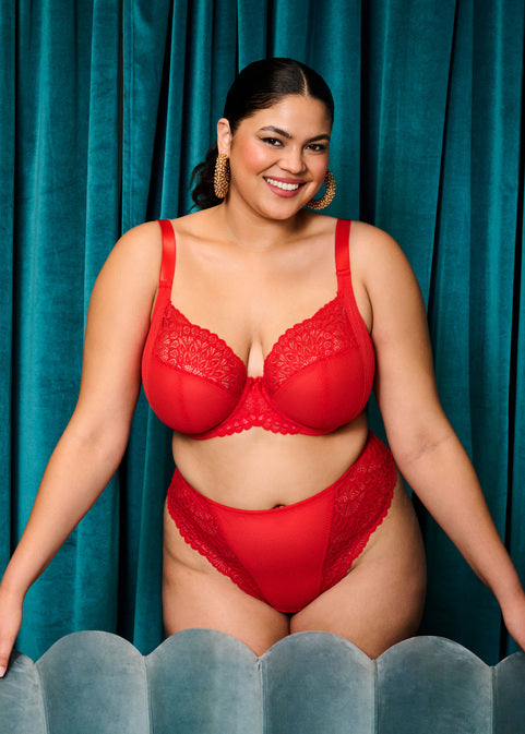 curvy woman wearing Red women's underwear with lace trim on a white background