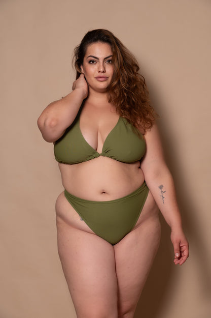 plussize woman wearing a green khaki bikini set against a beige background