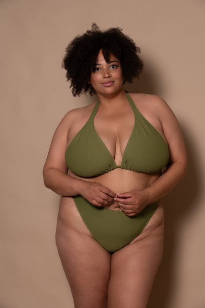 plussize woman wearing a green khaki bikini set against a beige background