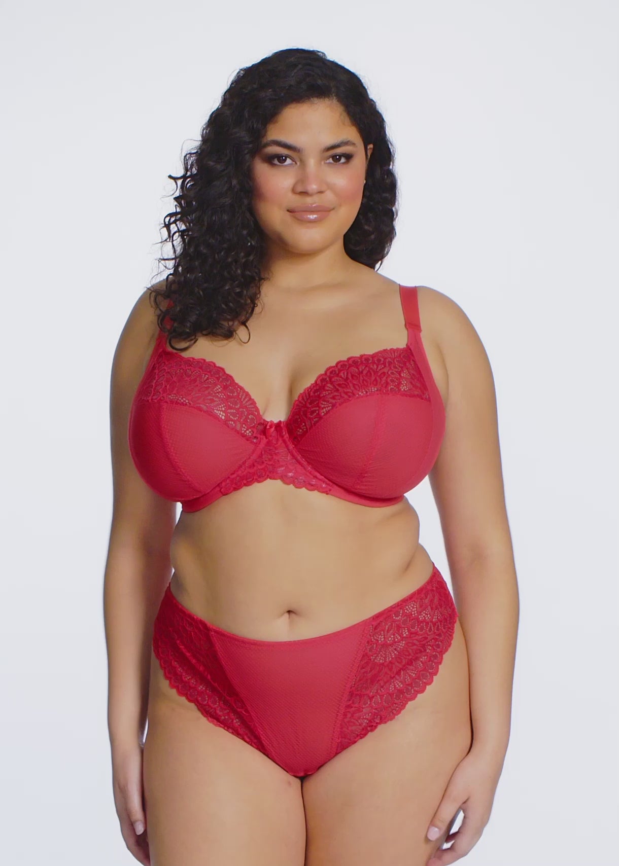 curvy woman wearing Red lace underwear on a white background
