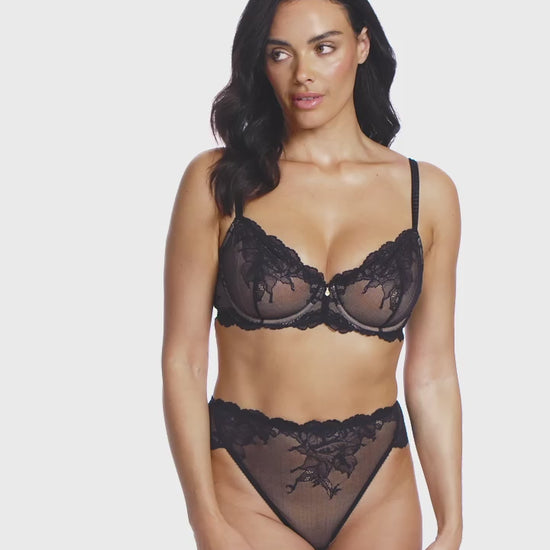 woman wearing a black lace bra with flower details with matching high leg brief