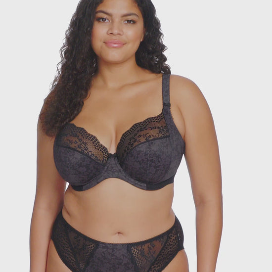 curvy Woman wearing a black lace lingerie set on a white background